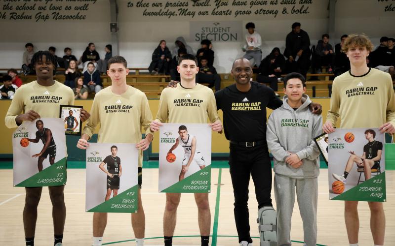 Photo courtesy Rabun Gap Athletics. Rabun Gap basketball seniors pose for a picture with first-year head coach Devin Liferidge (center) ahead of the Eagles’ 59-46 win over Asheville School on Feb. 7. The Eagles are 16-9 on the season with two games remaining before the state playoffs.