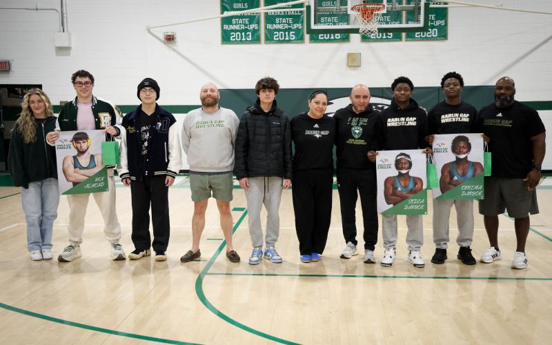 Photo courtesy Rabun Gap Athletics. Rabun Gap wrestling seniors pose for a photo with head coach Connor Bozzi (left center) and his staff as they are recognized on Feb. 7 before Rabun Gap’s basketball games.