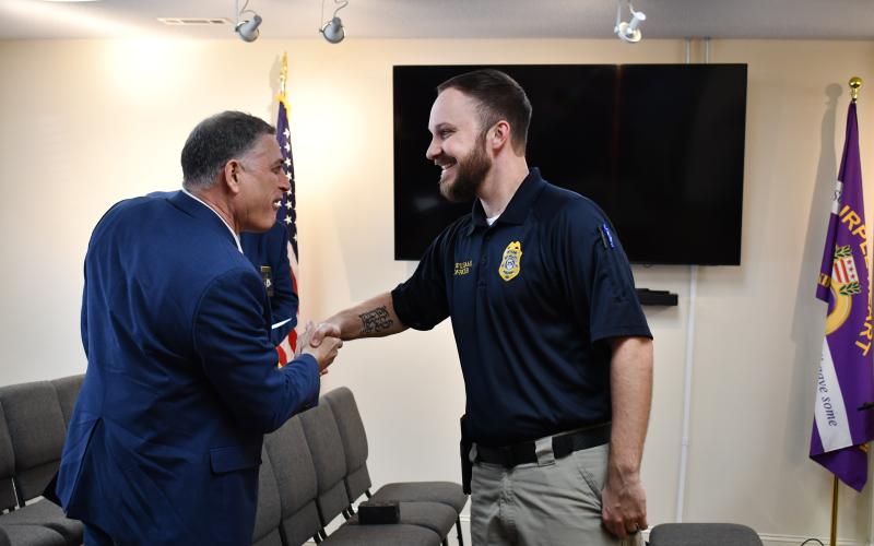 Megan Horn/The Clayton Tribune. U.S. Rep. Andrew Clyde of Georgia’s Ninth District, shakes hands with Sky Valley Police Officer Andrew Williams in Sky Valley Feb. 19. Williams was honored as a “Special Georgian of the Ninth” for a heroic house fire rescue in January.
