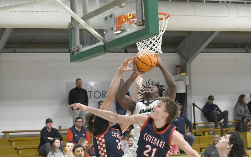 Wesley Branch/The Clayton Tribune. Rabun Gap senior RJ Lacossade fights through the Covenant Day defense for a layup in Rabun Gap’s 56-49 win over Covenant Day School on Feb.17. Lacossade, a captain for the Eagles, has helped lead the program to the state playoffs each of the last three seasons.
