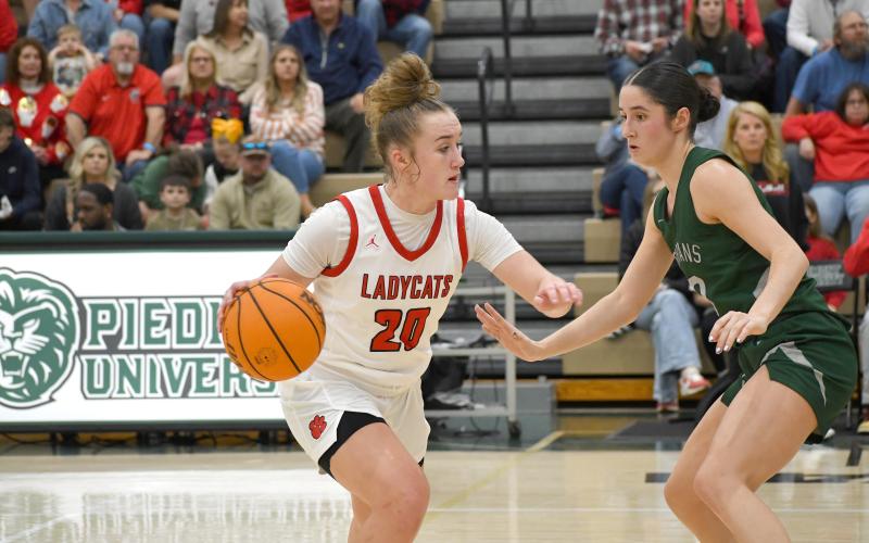 Wesley Branch/The Clayton Tribune. Rabun County freshman Millie Southards surveys the court in Rabun County’s 50-38 loss to Athens Academy in the region title game on Feb. 20 at Piedmont University. Southards and the Lady Cats are the No. 7 seed in the state playoffs, which started on Tuesday. RCHS would defeat Armuchee 63-42 in the playoffs opening round.