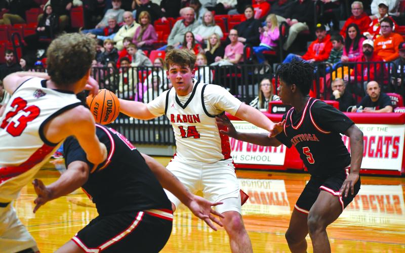 Wesley Branch/The Clayton Tribune. Rabun County freshman Cord Burrell sets up senior Hayes Free with a backdoor pass in Rabun County’s 80-47 first round playoff win over Chattooga on Feb. 24.