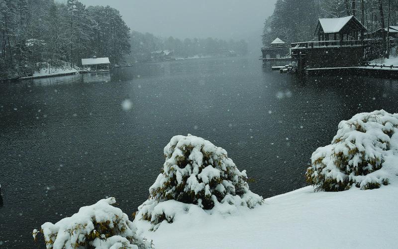 Enoch Autry/The Clayton Tribune. Large and small flakes float down onto Lake Burton at Perrin Cove Saturday morning as Rabun County receives an excess of 7 inches of snow.