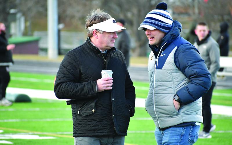 Wesley Branch/The Clayton Tribune. Georgia head football coach Kirby Smart and East Tennessee State head football coach Will Healy talk during the Rabun Gap College Coaches Social on Jan. 28. Multiple players in attendance received a scholarship offer from Georgia following the event, and Rabun Gap’s Jaxon Totherow received an offer from ETSU, marking his first Division I offer.