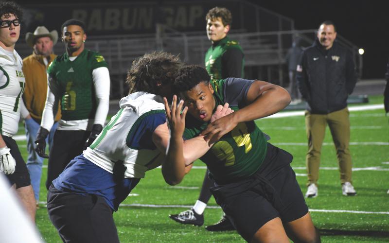 Wesley Branch/The Clayton Tribune. Rabun Gap sophomore Isaac Lukuni fights through an offensive lineman in the one-on-one portion of the Rabun Gap College Coaches Social on Jan. 28. Lukuni has received offers from Georgia, Miami (Fla.), Auburn and several others.