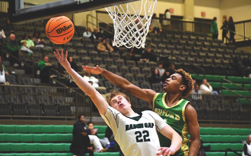 Wesley Branch/The Clayton Tribune. Rabun Gap-Nacoochee School junior Joonatan Tartu fights through the Buford defense for an and-one layup in Rabun Gap’s 61-56 win over Buford on Jan. 30. Tartu converted the and-one pictured above and made an important block late in the game in the Eagles’ victory.