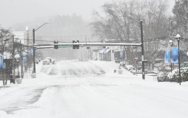 Wesley Branch/The Clayton Tribune. Main Street in Clayton truly resembled a winter wonderland on Jan. 31 as snow coated the road and put a momentary halt to downtown business activity.