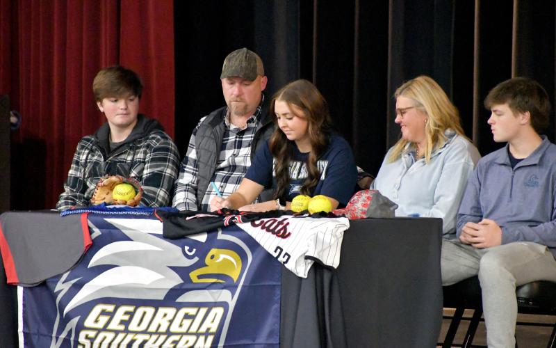 Wesley Branch/The Clayton Tribune. Rabun County softball senior Presley Burrell signs her letter of intent to Georgia Southern University East Georgia while accompanied by her family on Rabun County’s campus on Feb. 5. Burrell earned All-Region second-team honors in her senior season.