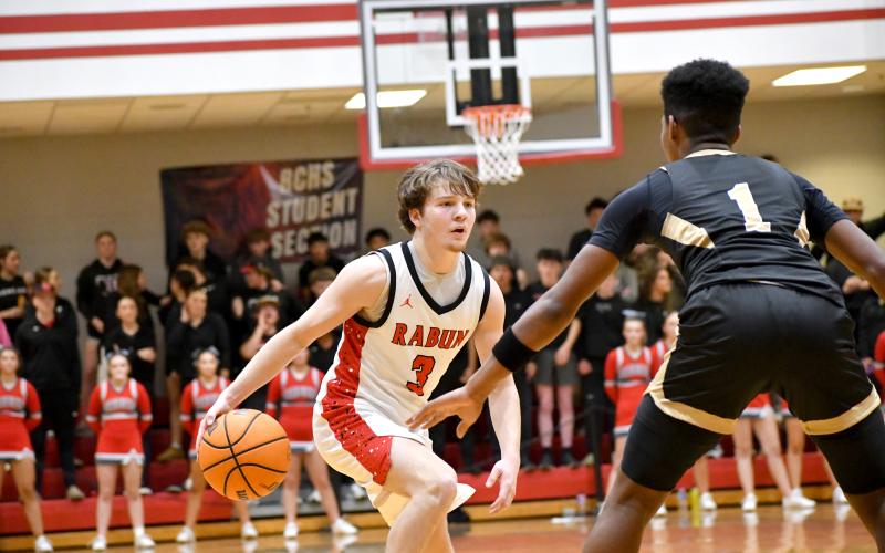 Wesley Branch/The Clayton Tribune. Rabun County senior Huey Blalock sizes up Commerce defender Jeremiah Jarrells in Rabun County’s 62-50 win over Commerce on Feb. 12. Blalock scored a game-high 29 points in the win.