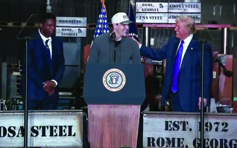 Video image/Fox5 Atlanta. Rabun County standout and current Georgia quarterback Gunner Stockton is greeted at the podium in Rome, Ga., on Feb. 19 by President Donald Trump. Standing with Stockton and Trump is Herschel Walker, Bulldog great and current ambassador to The Bahamas.
