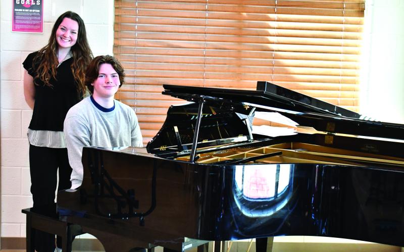 Megan Horn/The Clayton Tribune. Choir Teacher Tessa Backer, left, was selected as the 2025-2026 STAR Teacher by STAR Student Gavin Sharpe, who sits at the piano. Sharpe enjoys playing the piano and composing music, and said Backer has been an influential role model for him in music.