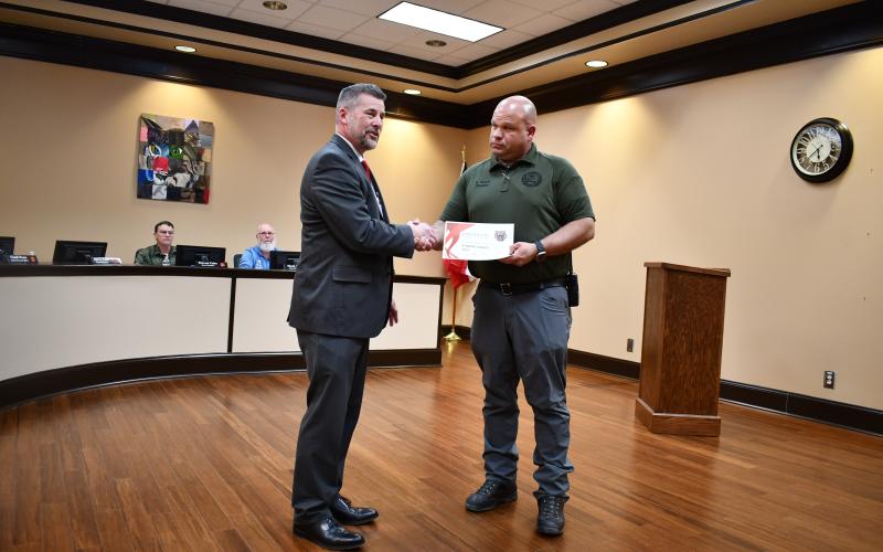 Megan Horn/The Clayton Tribune. Rabun County EMA Director Brian Panell, right, accepts a certificate on behalf of the Rabun County EMA/Search and Rescue, from Rabun County Schools Superintendent Steven Cole at the Feb. 23 Board of Education meeting. Panell said it’s a “team effort” when it comes to helping community members, and thanked all of the volunteers for their hard work and dedication.