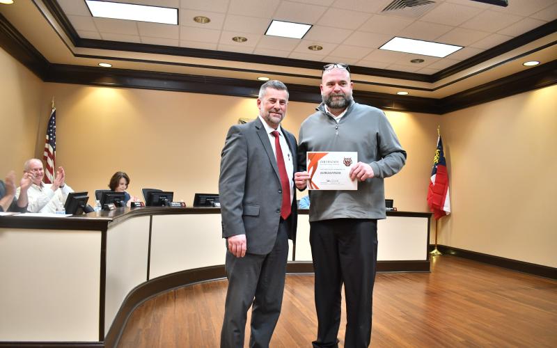 Megan Horn/The Clayton Tribune. Rabun County Superintendent Steven Cole, left, recognizes Georgia Power for their efforts during Winter Storms Fern and Gianna and presents a certificate for exceptional support on Feb. 23, to Georgia Power’s Northeast Area Manager Jeremy Spradlin. Cole also presented a certificate to Habersham EMC.