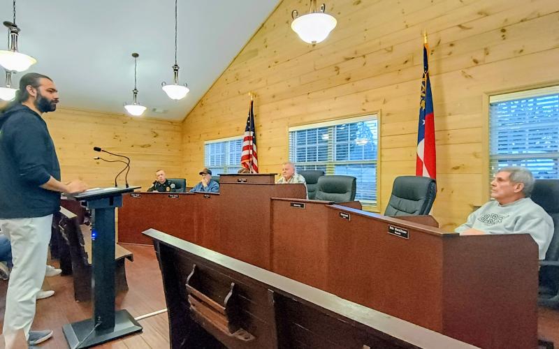 Megan Horn/The Clayton Tribune. Alim Dhanani, an owner of KASA 4 LLC, and Tiger Biscuit Place (BP) General Store, speaks to Tiger Town council members Monday, Feb. 10, about a plan to add gas pumps and rezone the adjacent Bridge Creek Road property. Aslam Dhanani is the other owner and was present at the meeting as well.