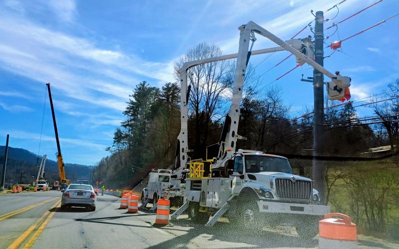Megan Horn/The Clayton Tribune. Crews  work on the power lines on Highway 441 in Rabun Gap. Delays up to an hour were caused in both directions by the work.