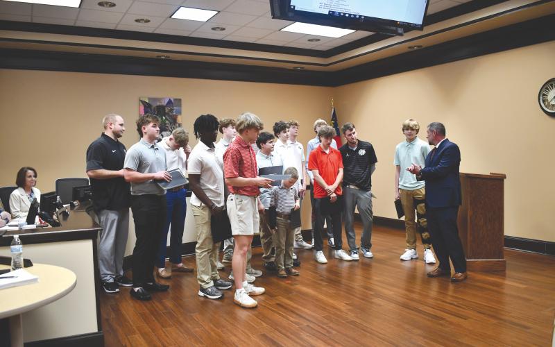 Megan Horn/The Clayton Tribune. Rabun County Schools Superintendent Steven Cole, far right, speaks to the boys basketball team and commends the seniors on their commitment to the team and the legacy they leave behind when they graduate. RCHS defeated Southwest on March 13 for the state title.