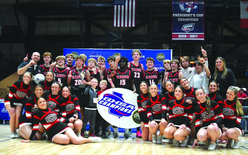 Enoch Autry/The Clayton Tribune. The Rabun County boys basketball team and RCHS cheerleaders pose for a photo after the basketball team's 52-43 state championship victory versus Southwest on March 13 at the Macon Coliseum