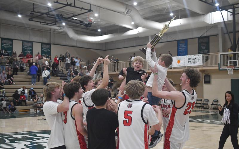Wesley Branch/The Clayton Tribune. The boys are lifted up above the players during the celebration for capturing the region title at Piedmont University.