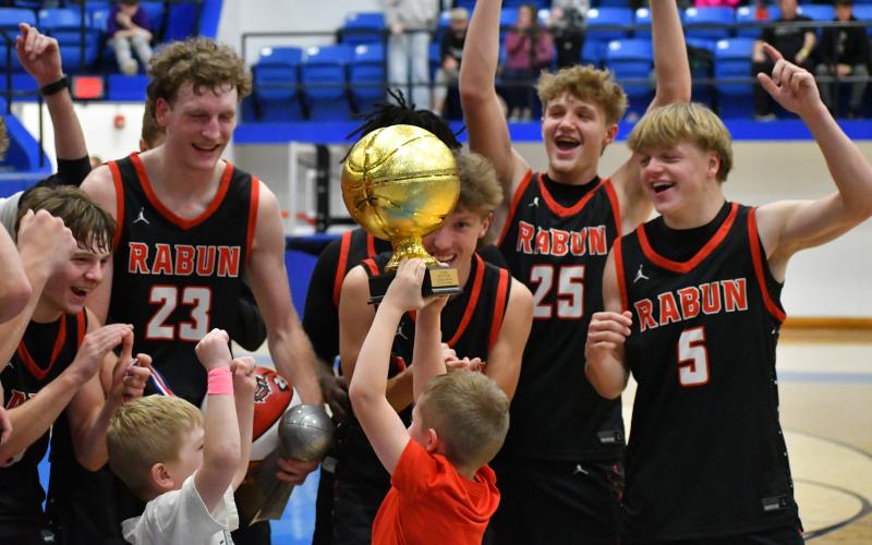 Wesley Branch/The Clayton Tribune. Cal Burrell and Reeves Page celebrate with the Wildcats for winning the “Battle of the States Tournament” at Towns County.