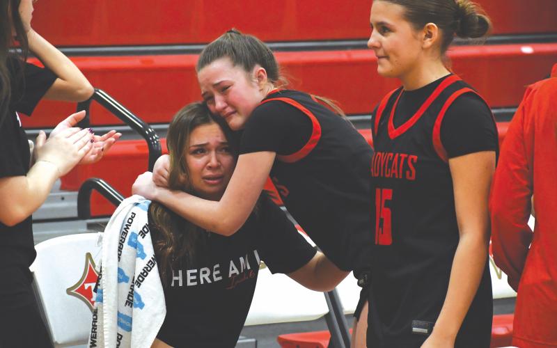 Wesley Branch/The Clayton Tribune. Rabun County sophomore Maci Dixon consoles Rabun County senior Loren Mazarky after the Lady Cats’ 46-44 loss to Thomasville in the Elite Eight on March 3 at Thomasville High School. Mazarky is one of five senior players for the Lady Cats.