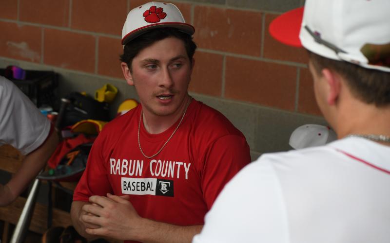 Wesley Branch/The Clayton Tribune. New Rabun County assistant baseball coach Grayson Carver addresses the Rabun County baseball team in the dugout during the Wildcats’ March 6 doubleheader versus Providence Christian Academy at home. Carver returns to the RCHS baseball program after formerly playing for the Wildcats and graduating in 2022.