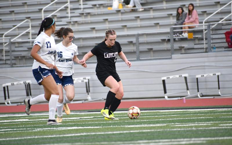 Wesley Branch/The Clayton Tribune. Rabun County freshman Millie Southards fights off Elbert County defenders in Rabun County’s 9-1 win over Elbert County on March 6 at home. Southards scored three goals in the win.