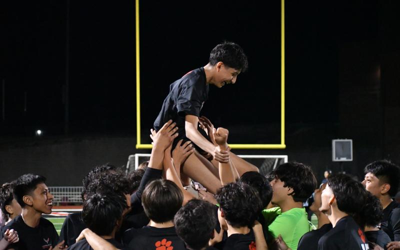 Wesley Branch/The Clayton Tribune. The Rabun County boys soccer team lifts freshman Frank Lopez in celebration following its 7-3 win against Elbert County on March 6 at Rabun County High School.