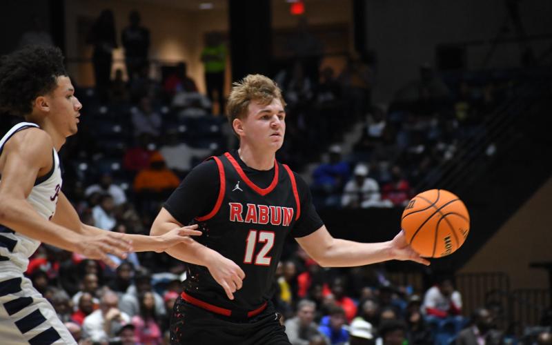 Wesley Branch/The Clayton Tribune. Wildcat junior Reed Burrell makes a pass during the March 13 state championship game against Southwest in the Macon Coliseum. RCHS head coach David Adcock calls Burrell a “Swiss army knife” on the team.