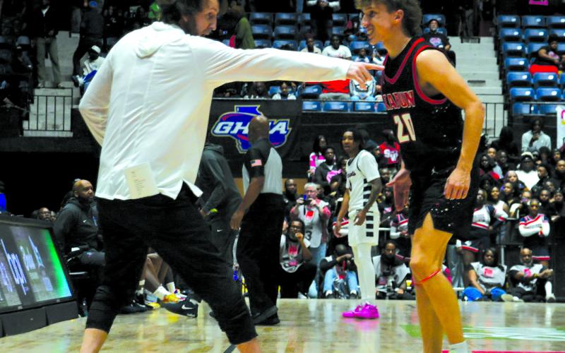 Enoch Autry/The Clayton Tribune. RCHS head coach David Adcock directs Colton Crane in the final seconds of the state championship game. The senior came off the bench to hit two free throws with 37.3 seconds left in the game to help the Wildcats ice the win over Southwest. Junior Landan Bedingfield added another free throw at the end to make the final score 52-43 in Macon.