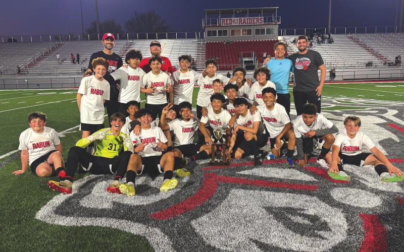 Submitted photo. The Rabun County Middle School boys soccer team poses with the region-winning trophy after defeating Habersham County 2-0 in the championship game on March 14.