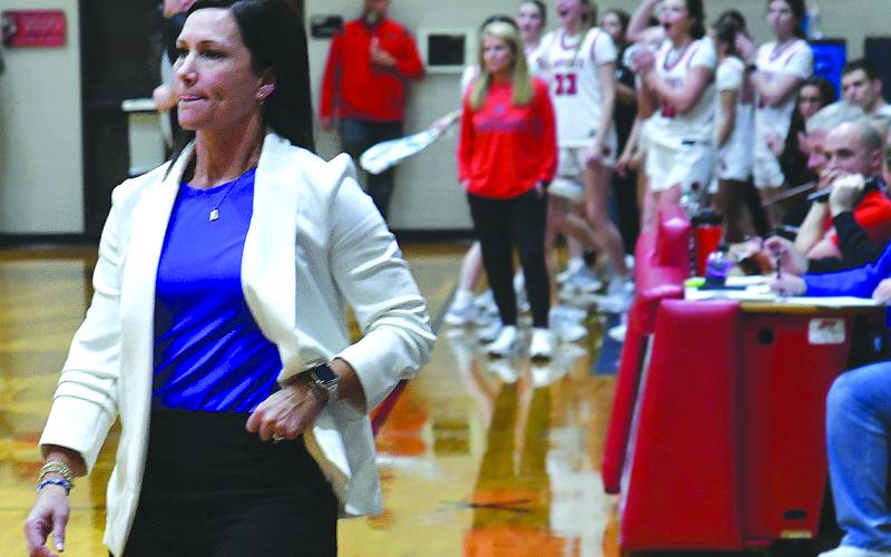 Enoch Autry/The Clayton Tribune. Model girls head coach Sally Echols reacts to a Rabun County layup in Tiger in the Class A Division I state playoffs as the Lady Cats’ bench celebrates the bucket in the 56-43 Feb. 27 win to advance to the Elite Eight. Like Echols, Rabun County head coach DeeDee Dillard (background) has more than 400 wins in her coaching career.