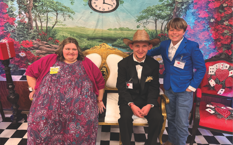 Katie Hamby/The Clayton Tribune. Shelby English of Clayton and Zack Montgomery of Mountain City sit next to volunteer Mason Beck.