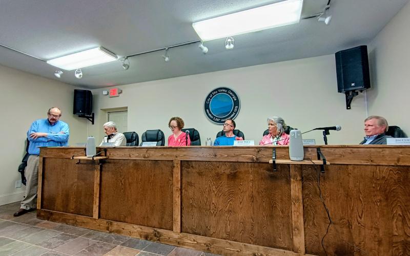 Megan Horn/The Clayton Tribune. Sky Valley City Manager Jason Streetman reads aloud two different proposed resolutions to rescind grant funding and discontinue efforts to construct a sanitary sewer system during the March 23 special called meeting. The total grant funding is $5 million. A new vote is scheduled for Thursday, March 26, at 3 p.m. at Sky Valley City Hall.