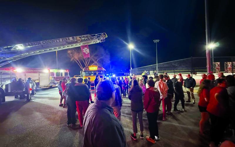 Submitted Photo. This is a scene from the welcome home gathering at Rabun County High School for the Rabun County boys basketball team following its 52-43 state championship victory in Macon on March 13. The bus rolled into the parking lot just before 10 p.m. after making the return drive from Central Georgia with a state title trophy in their possession. This is the first RCHS boys hoops state title in school history.