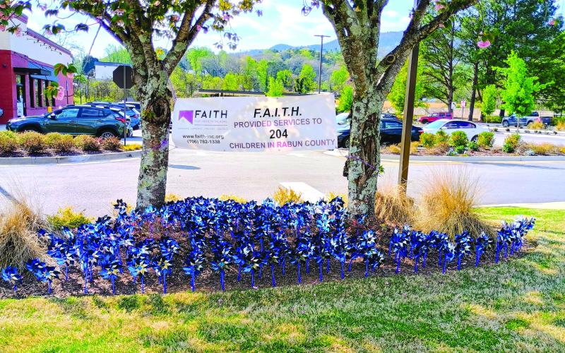 Megan Horn/The Clayton Tribune. Blue pinwheels can be seen spinning at Chick-fil-A Clayton. Each pinwheel represents a child in Rabun County who was helped by local nonprofit Fight Abuse In The Home (F.A.I.T.H.) last year. F.A.I.T.H. provided services to 204 children in Rabun County in 2025. Pinwheels can also be seen at the Rabun County Division of Family and Children Services (DFCS) office. April is Child Abuse Prevention Month.