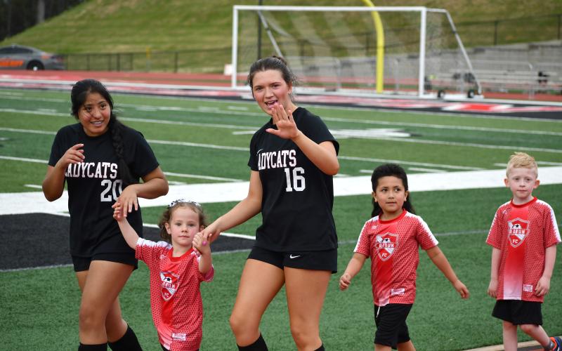 Wesley Branch/The Clayton Tribune. Denise Zaldivar and Hayden Bass were among the Lady Cats who walked with Rabun County Recreation Department soccer players as part of “Rec Night” on March 31 at Frank Snyder Memorial Stadium.