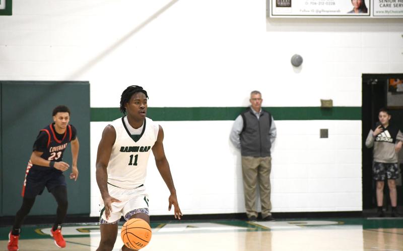 Wesley Branch/The Clayton Tribune. Rabun Gap senior RJ Lacossade races down the floor during Rabun Gap’s 56-49 playoff win over Covenant Day on Feb. 17. Lacossade is just the seventh basketball player from Turks and Caicos to make it to the collegiate level.