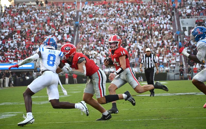 Wesley Branch/The Clayton Tribune. Georgia quarterback Gunner Stockton searches for a running lane during Georgia’s 43-35 win over Ole Miss on Oct. 18, 2025. Stockton will host a football camp for youth aged 6-16 on June 20 at Lakeview Academy in Gainesville, Ga.
