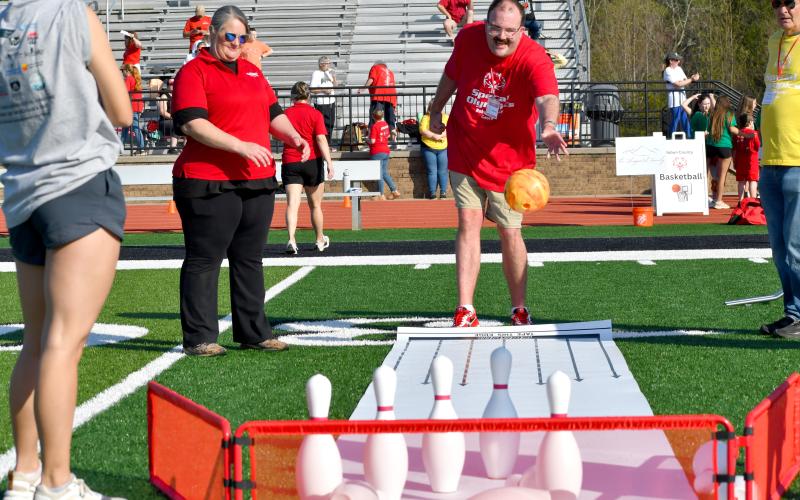 Wesley Branch/The Clayton Tribune. Adult athlete Stephen Green looks to knock down the bowling pins at the Rabun County Special Olympics on April 2 at Frank Snyder Memorial Stadium. If you look closely, you can see Green’s University of Georgia themed shoes, which he excitedly showed-off during the day.