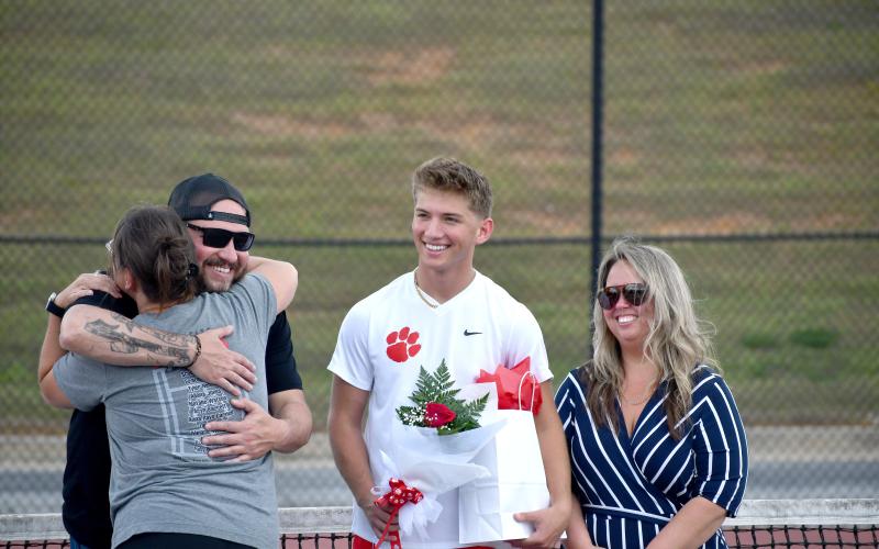 Wesley Branch/The Clayton Tribune. Rabun County senior Ashden Denning smiles as he is recognized for senior night before Rabun County’s match versus Commerce on April 2. Denning has played tennis at RCHS since his sophomore year.