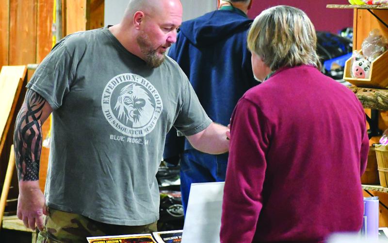 Enoch Autry/The Clayton Tribune. Former Clayton Police Chief Andy Strait, who has attended multiple paranormal events, talks with Dr. John Stamey (right), the organizer of the Georgia Bigfoot Conference &amp; North Georgia Comicon during check-in at the March 21 in Rabun County. Plans are in the works to have the conference return to a local venue next year and the World UFO Conference is scheduled to be in Rabun County on Aug. 15.