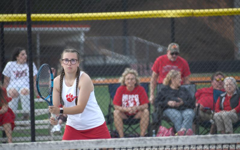 Wesley Branch/The Clayton Tribune. Rabun County senior Caroline Marshall awaits a serve during her match versus Commerce on April 2 in Rabun County’s senior night win. Marshall is the lone senior on the RCHS girls tennis team.