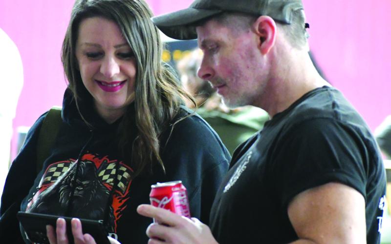 Enoch Autry/The Clayton Tribune. Matt Delph shows fellow featured speaker Jessica Jones a video of one of his research expeditions during the Georgia Bigfoot Conference &amp; North Georgia Comicon on March 21 at Big Shoals Junction in Tiger. The conference returned to Rabun County after being in Mt. Airy, Ga., last year.