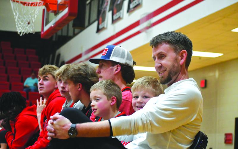 Enoch Autry/The Clayton Tribune. Rabun County head boys basketball coach David Adcock has a laugh with the “goon” Cal Burrell and Reeves Page during the March 26 state championship celebration at the RCHS gym.