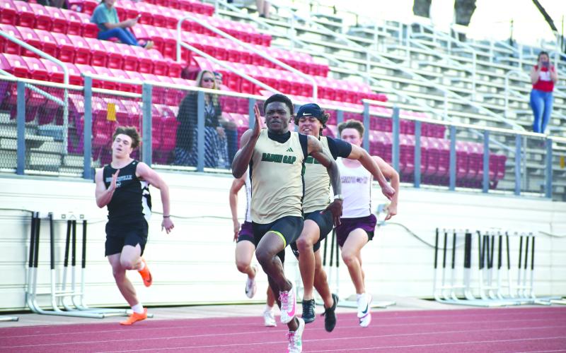 Wesley Branch/The Clayton Tribune. Rabun Gap senior CJ Willingham runs during the track events at the Bo James Invitational at Rabun County High School on April 2. Willingham set new Bo James Invitational records for the 100 and 200-meter races with times of 10.81 and 21.94, respectively.