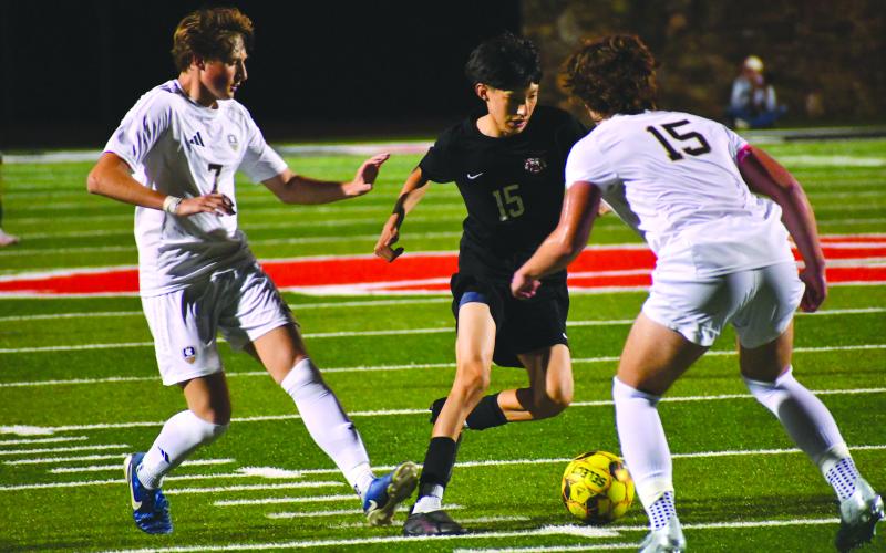 Wesley Branch/The Clayton Tribune. Rabun County sophomore Carlos Lopez-Justice navigates the White County defense in Rabun County’s 1-0 win against White County on April 3. Lopez-Justice drew multiple fouls throughout the contest, creating scoring opportunities for the Wildcats and frustrating the Warriors’ defenders.