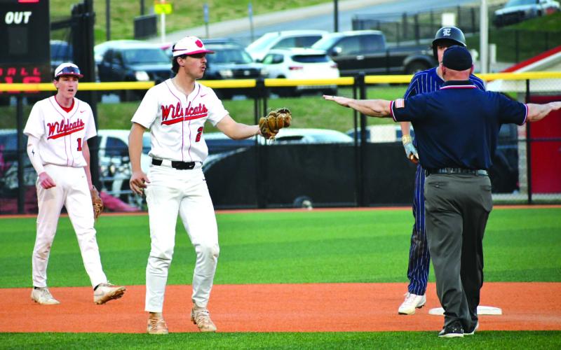 Enoch Autry/The Clayton Tribune. Senior second baseman Ty Truelove tries to convince the umpire he got the tag on Elbert County baserunner Brody Baker, but Baker is called safe in the Blue Devils’ 7-3 win over the Wildcats on March 31.
