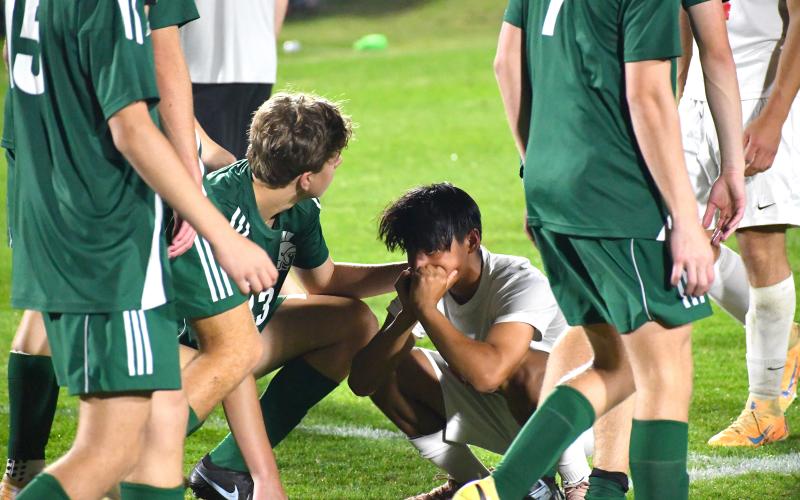 Wesley Branch/The Clayton Tribune. Athens Academy players console Rabun County sophomore Alan Lozada after Rabun County’s loss to Athens Academy on April 15. Lozada and the Wildcats will head to Armuchee on April 22 for the first round of the state playoffs.