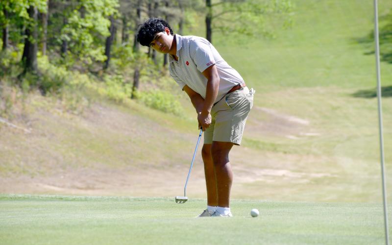 Wesley Branch/The Clayton Tribune. abun County senior Roberto Diaz watches his putt roll toward the hole during Rabun County’s golf match versus Union County on April 16 at Kingwood Resort. Diaz had the second best score for the RCHS boys team, posting a 41 in the nine-hole match.