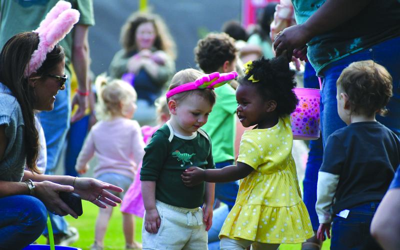 Enoch Autry/The Clayton Tribune. Haven Shirley, 2, hugs fellow Easter egg hunter Rhett Strasser, 1-and-a-half, during the hunt at the April 2 annual Rabun County Recreation Department event.